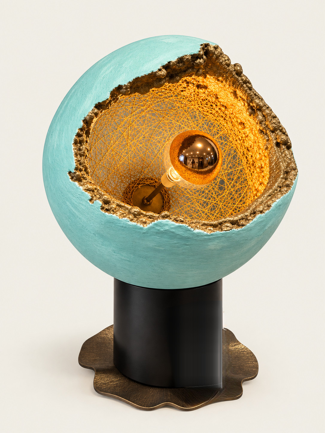 Luna de Oro — a sphere opened to reveal a woven gold interior and a single mirrored bulb